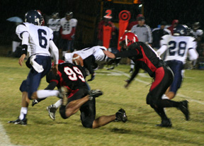 Kyler Shumway, 99, knocks the ball loose from the ballcarrier as Branden Waller moves in to make the recovery.