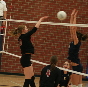 Kayla Johnson spikes the ball against Grangeville at the Genesee Tournament. #4 is Megan Sigler.