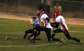 Derek Schaeffer and Conner Rieman race Genesees quarterback to a loose ball. Genesee recovered, but suffered a 20 yard loss on the play.