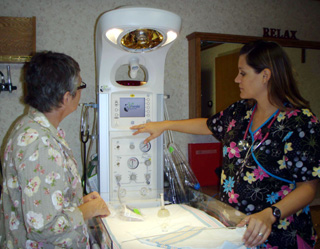 Pam McBride, SMHC grants coordinator, listens as Leslie Mager, RN, SMHC explains the various features of the infant warmer recently purchased by St. Marys Hospital with the help of two Foundation grants.
