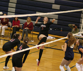 Sam Frei goes for the kill at Grangeville. At left are Sam Poxleitner and Megan Sigler.