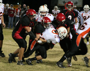 The defense gang-tackles the league's leading rusher, Marshall Williams of Troy. On the tackle are Kyler Shumway, Derek Schaeffer and Branden Waller. #2 in the background is Conner Rieman. Prairie held Williams to just 7 yards on 6 attempts.