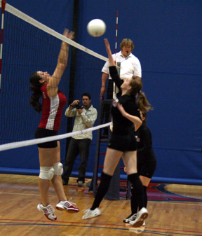 Kayla Johnson tips the ball past a C.V. blocker.