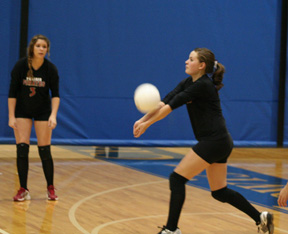 Meaghan Bruner makes a pass against C.V. as Sam Frei watches.