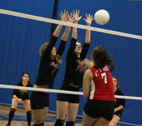 Kayla Johnson blocked this C.V. spike attempt as she and Shelby Duman put up a wall. Francesca Johnson and Sam Frei are in the background.