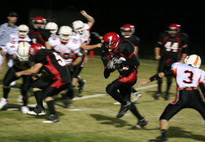 Tyrell Langston gets a key block from Josh Roeper on a 2-point conversion play. In the background is Joe Schumacher, 44.