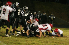Branden Waller recovers a Deary fumble. Kyler Shumway, 99, and Devin Schmidt, 4, helped to force the fumble. At left is Conner Rieman.