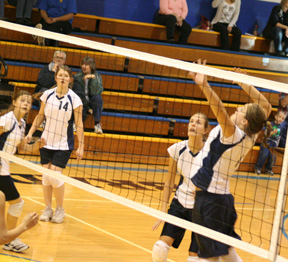 Jamie Chmelik winds up for a spike as from left Brooke Schumacher, Rachel Wemhoff and Savanah Prigge look on.
