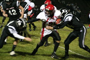 Justin Schmidt stiffarms one Deary defender but the one to the right is going to make the tackle.