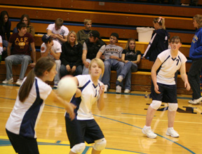 Rachel Wemhoff makes a pass as Cassidee Stubbers and Nicole Wemhoff look on.
