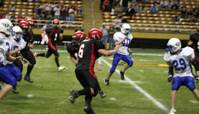 Branden Waller breaks into the secondary on his way a 54 yard TD run. Behind Waller quarterback Kyle Holthaus is about to make a block to take out the pursuers behind him. Most every other Pirate in the photo made a block somewhere in his serpentine run downfield.
