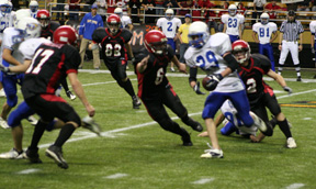 Branden Waller and Conner Rieman close in from behind while Kyle Holthaus cuts off one avenue of escape for Raft River’s H.D. Tuckett on a running play. In the background is Derek Schaeffer.