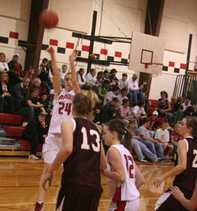 Kayla Johnson puts up a shot. At right is NaTosha Schaeffer.