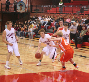 David Sigler drives into the lane against Troy. At left is Devin Schmidt while at right is Derek Schaeffer.