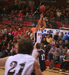 Devin Schmidt shoots in the Grangeville game. In the foreground is Conner Rieman.
