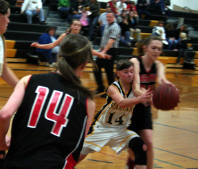 Kayla Johnson battles a Timberline player for a loose ball. Back to the camera is MaKayla Schaeffer.
