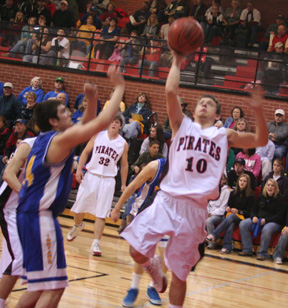 Kyle Holthaus scores a lay-up against Nezperce. In the background is Branden Waller.