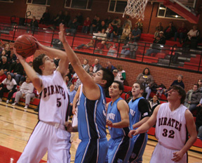 Seth Guyer looks to shoot against Lapwai. At right is Branden Waller.