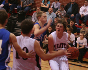Conner Rieman grimaces as he gets ready to go up for a shot against Genesee. At left is Kyle Holthaus.