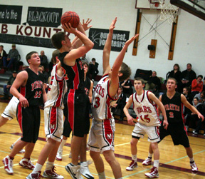 Andrew Gabica puts up a shot from the low block against the Moscow JV. At left is Branden Waller and at right is Devin Schmidt. In the background behind Gabica is Conner Rieman.