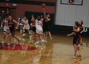 Amber Holthaus makes a pass to Megan Sigler after making a steal at Deary. Other Prairie players shown from left are Meaghan Bruner, Mary Shears and Kayla Johnson.