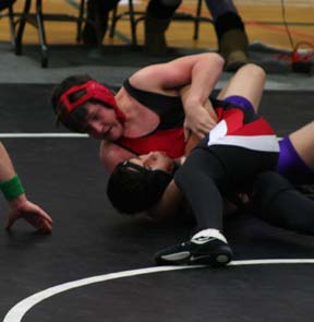 Garrett Schmidt is about to pin his opponent.