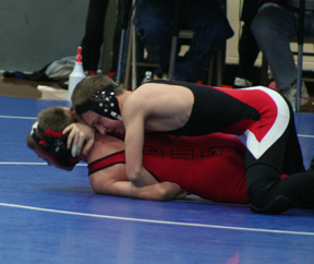 Alex Duman attempts to roll his opponent over. He also finished 1st in his weight class at the Orofino Tournament.