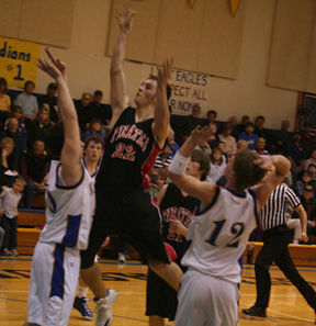 Andrew Gabica goes up for a shot in the lane at Nezperce. At right is Conner Rieman.