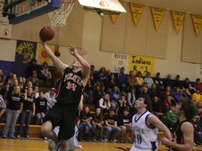 Branden Waller scores a layup against Nezperce. At right is Conner Rieman.