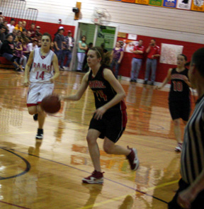 Kayla Johnson leads a break at C.V. At right is Megan Sigler.