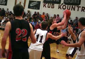 David Sigler gets past Kamiahs Jack Nygaard for a lay-up attempts. At left is Andrew Gabica.