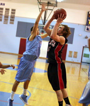 Lapwai defenders try to keep David Sigler from scoring down near the low block.