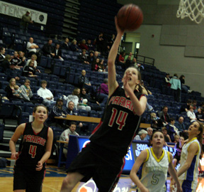 MaKayla Schaeffer scores a lay-up against Genesee. At left is Meaghan Bruner.