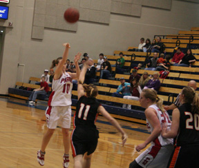 Megan Sigler puts up a 3-point shot against Kendrick. At right is Mary Shears.