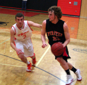 David Sigler drives past Troy's Hayden Kanikkeberg.