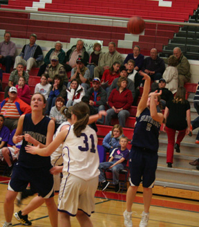 Jamie Chmelik puts up a shot from the side. At left is Savanah Prigge.