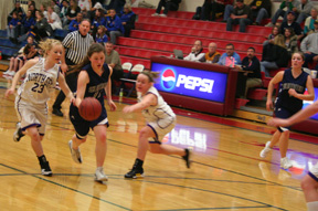Rachel Wemhoff drives toward the hoop in the North Gem game at State. At right is Jamie Chmelik.
