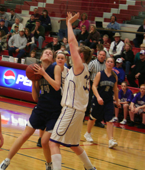 Savanah Prigge looks for an opening for a shot against North Gem. At right is Jamie Chmelik.