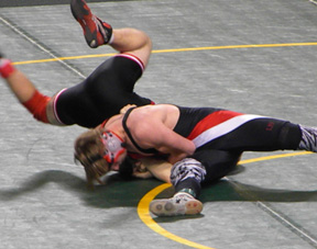 Brandon Poxleitner has Scott Jensen of Parma flailing around as he tries to score the pin in his quarterfinal match at state. Photo by Cindy Schumacher.