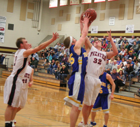 Branden Waller battles Raft Rivers H.D. Tuckett for a rebound. At left is Devin Schmidt and behind Devin is Conner Rieman.
