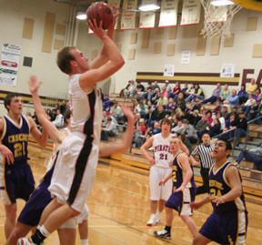 Devin Schmidt goes for a score against Cascade. In the background is Conner Rieman.