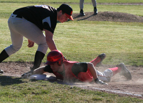 Kyle Holthaus gets back safely to first ahead of a pickoff throw.
