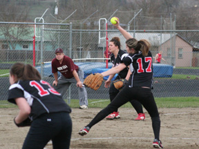 Sammi Frei is about to unleash a pitch. Also shown are Meaghan Bruner and Hilaree VanderPas.