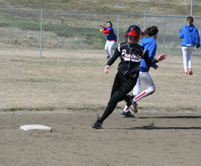 Tanna Schlader rounds second on a triple as the McCall-Donnelly outfielder is just now ready to throw the ball back in.