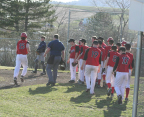 David Sigler nears home plate after his homer against Lewis County where the entire team waits to congratulate him. He repeated the feat in the game against Troy.