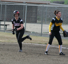 Megan Sigler checks out the pitch as she takes off for second with a stolen base.