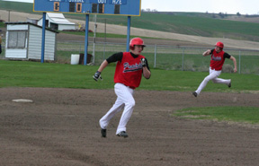 Kyle Holthaus heads for third as Conner Rieman pulls into second with a double at Genesee last week.