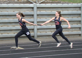 NaTosha Schaeffer hands off to sister MaKayla Schaeffer for the final leg of the 4x100 relay at the All-Star meet.