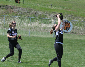 Megan Sigler drifts into the outfield to catch a popup against Genesee as Savanah Prigge comes in to back up the play.