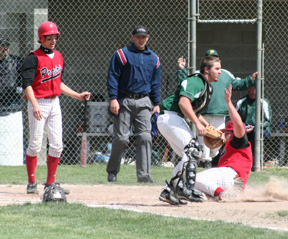 Joe Schumacher scores a run in the second Potlatch game as on deck batter Justin Schmidt looks on.